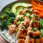Bang Bang Chicken Bowl (Quick, Creamy & Sensational Dinner in 25 Minutes) 9 Assembled Bang Bang Chicken Bowl with spicy mayo, grilled chicken, rice, and fresh vegetables