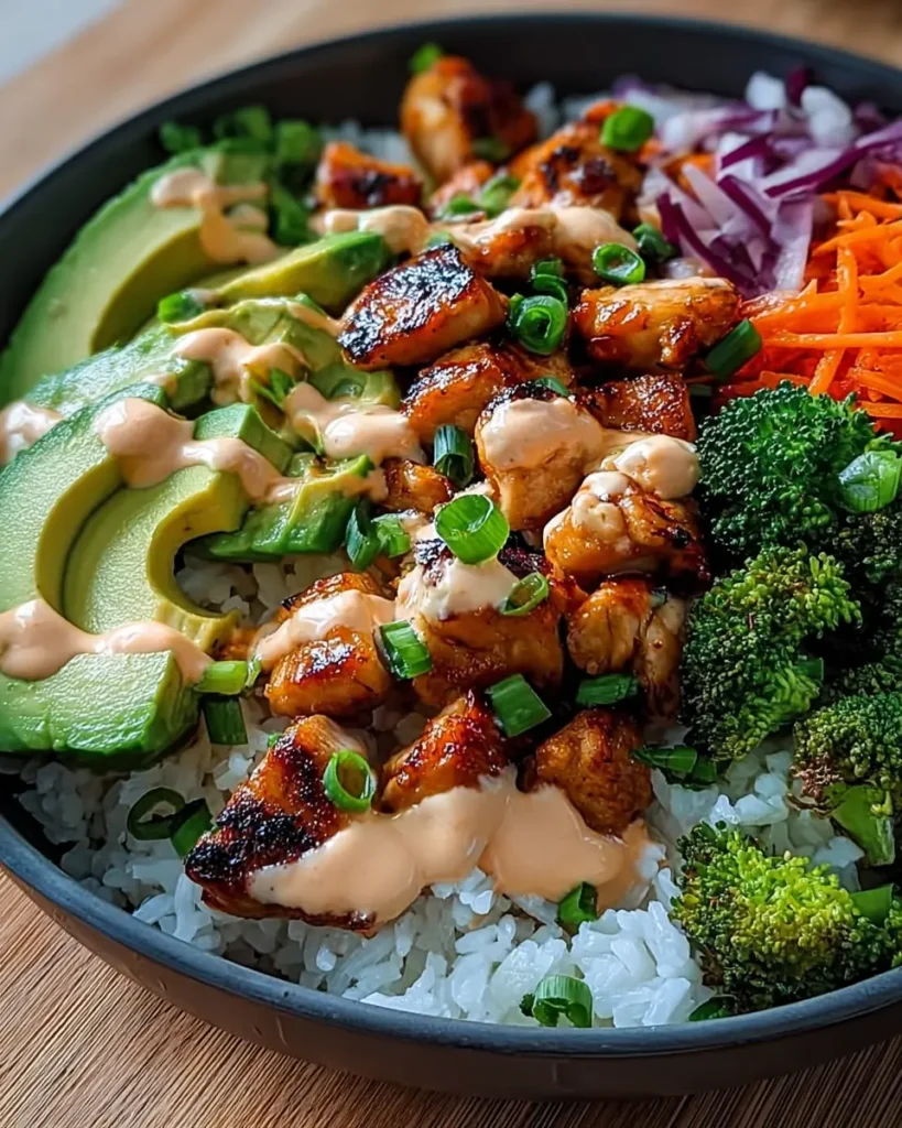 Bang Bang Chicken Bowl (Quick, Creamy & Sensational Dinner in 25 Minutes) 7 Glazed bang bang chicken over rice with creamy sauce, avocado, and fresh vegetables