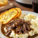 Beef Manhattan – Slow Cooker Classic with Comfort in Every Layer 6 Slow-cooked Beef Manhattan with mashed potatoes, brown gravy, and garlic bread on a plate