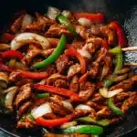 Black Pepper Chicken (Better Than Takeout!) 6 Black pepper chicken stir-fry with colorful bell peppers and onions in a cast iron skillet