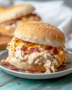 Creamy crack chicken sandwich with cheddar cheese and bacon on a sesame bun