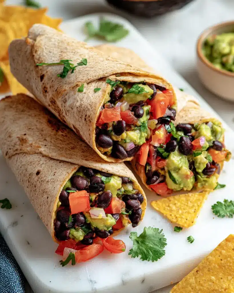 10 Easy Tortilla Wrap Recipes for Quick Lunches 11 Honey mustard chicken tortilla wrap with fresh lettuce on a bamboo board.