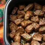 Air fryer garlic butter steak bites with crispy seared edges and garlic herb butter glaze