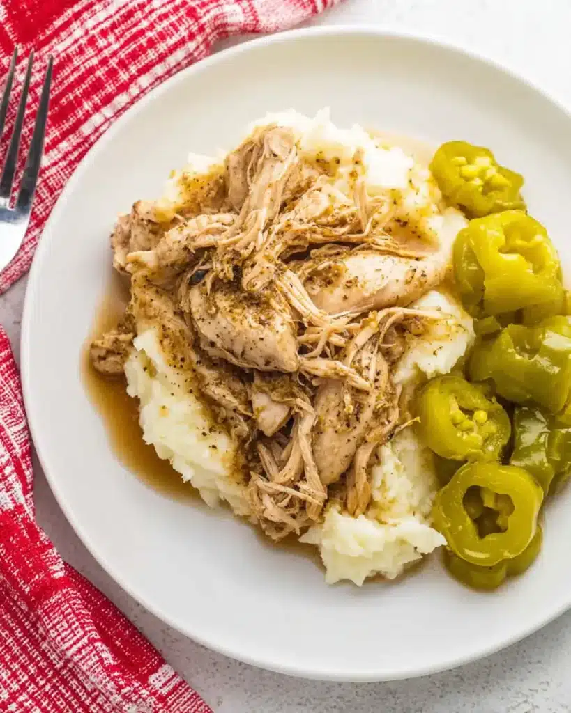 Mississippi Chicken (Crockpot Style) – Savory, Easy Comfort Food 8 Plated Mississippi chicken with pepperoncini and mashed potatoes on a white plate