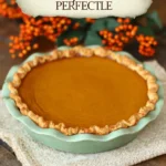 Practically Perfect Pumpkin Pie for Cozy Baking Days 9 Rustic homemade pumpkin pie with golden crust in green dish on fall-themed fabric background