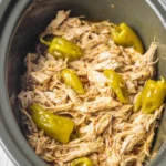 Mississippi Chicken (Crockpot Style) – Savory, Easy Comfort Food 9 Shredded Mississippi Chicken in a slow cooker with pepperoncini peppers