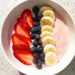 Fruit Smoothie Bowl Recipe: 5-Minute Strawberry Banana Bliss 9 Colorful fruit smoothie bowl with pink strawberry base, topped with banana slices, strawberries, and blueberries