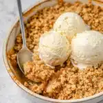 Simple Apple Crumble – Cozy Dessert for Any Occasion 17 Warm apple crumble with golden oat topping and vanilla ice cream scoops