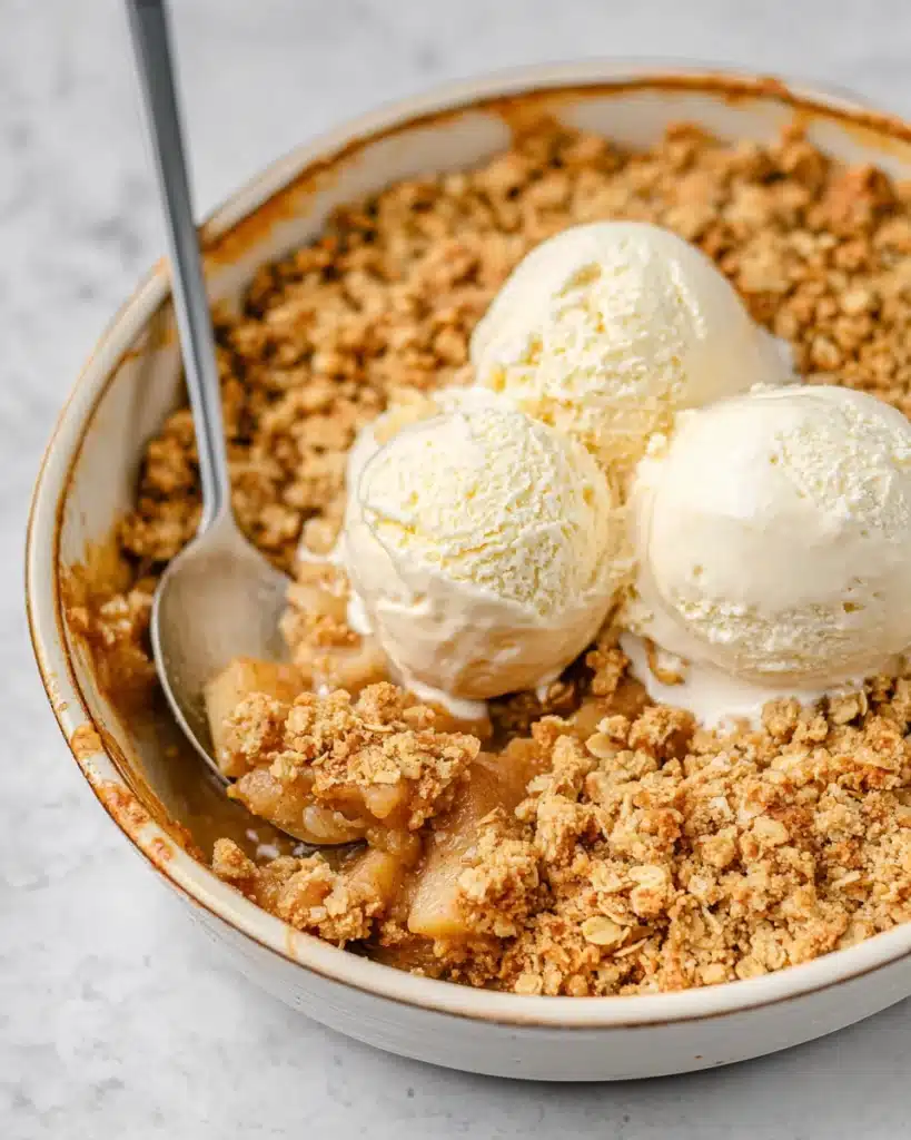 Simple Apple Crumble – Cozy Dessert for Any Occasion 12 Warm apple crumble with golden oat topping and vanilla ice cream scoops