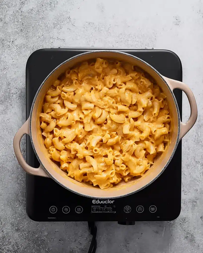 Buffalo chicken mac and cheese mixed in sauce inside a pot