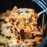 Crockpot Chicken Enchilada Casserole – Easy Cheesy Comfort 14 Crockpot chicken enchiladas casserole with melted cheese, black beans, corn, and shredded chicken served hot from a slow cooker.