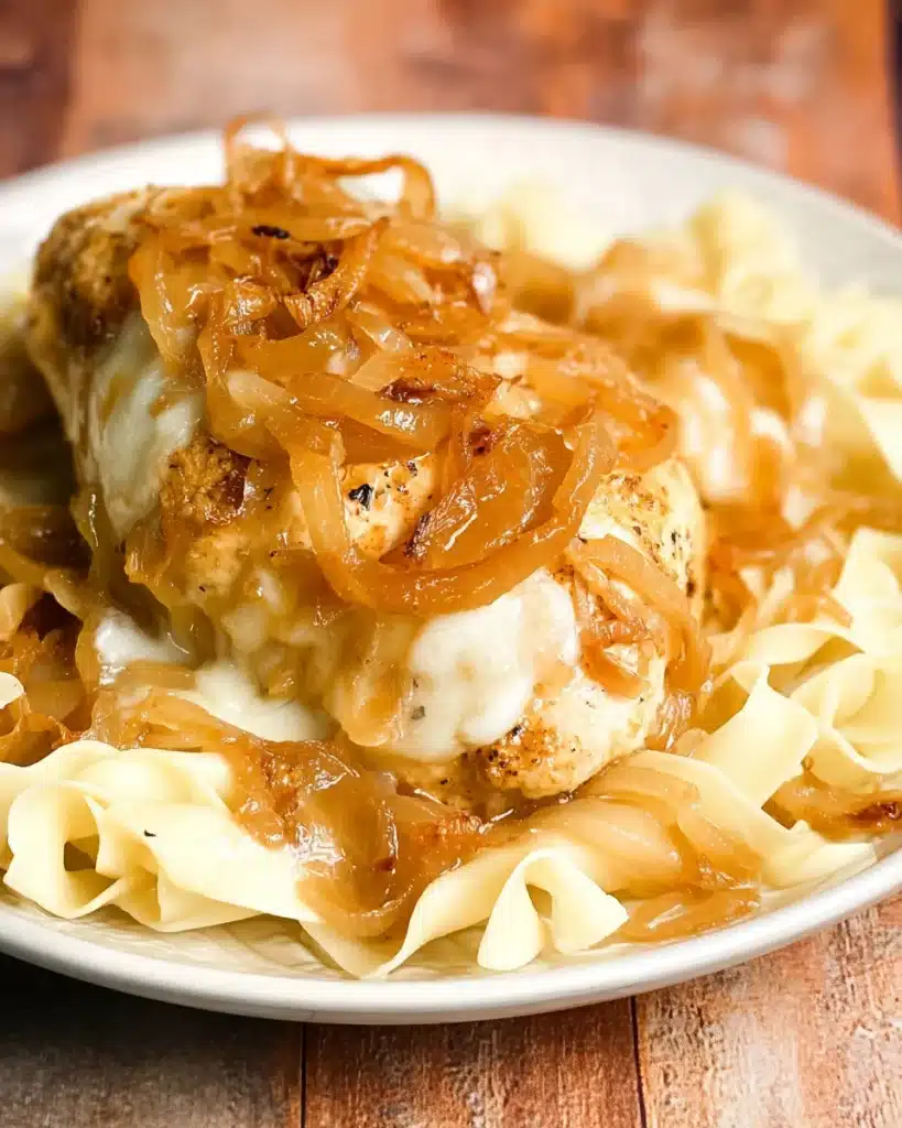 Crock Pot French Onion Chicken That’s Rich, Cheesy, and Easy 8 French Onion Chicken served over egg noodles with melted cheese and crispy onions