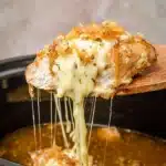 Crock Pot French Onion Chicken That’s Rich, Cheesy, and Easy 9 Melted provolone cheese stretching from Crock Pot French Onion Chicken with crispy onions on top