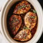 15 Easy & Delicious Crockpot Chicken Breast Recipes for Every Craving 9 Slow-cooked honey garlic chicken breasts in a crockpot with fresh thyme and sticky glaze.