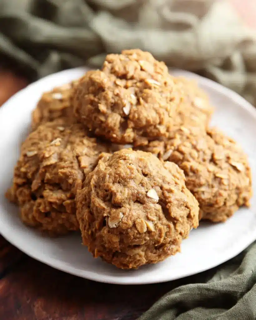 Soft Pumpkin Oatmeal Cookies – The Perfect Fall Treat 8 Soft pumpkin oatmeal cookies with chewy texture and visible oats served on a white plate