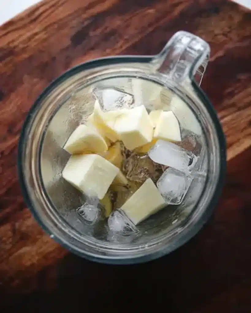 Homemade Apple Juice Recipe : Easy Canning Instructions 13 Cubed apples and ice in a blender jar on a wooden surface