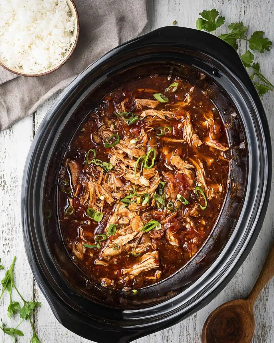Crock Pot Bourbon Chicken Recipe You’ll Crave 5 Crock pot bourbon chicken in glossy sauce with green onions and rice