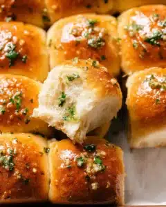 Golden garlic butter bread rolls with parsley on top