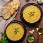 Hearty Cheddar Garlic Herb Potato Soup – Cozy and Flavorful 11 Creamy cheddar garlic herb potato soup in bowls with bread and green onion garnish