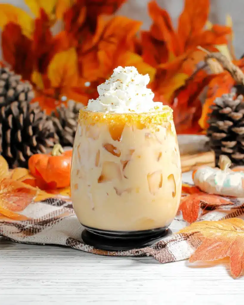 Pumpkin Spice White Russian Recipe | A Festive Fall Cocktail 9 Pumpkin Spice White Russian with whipped cream and sugar rim on rustic table