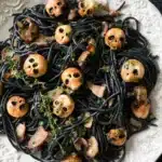 Spooky Pasta for Halloween with Creamy Bacon Sauce 14 Spooky pasta with squid ink spaghetti and carved mushroom skulls for Halloween dinner
