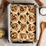 Apple Cinnamon Rolls Recipe | Soft, Gooey, and Perfect for Thanksgiving 11 Tray of unbaked apple cinnamon rolls with spiced filling, apples, and pecans