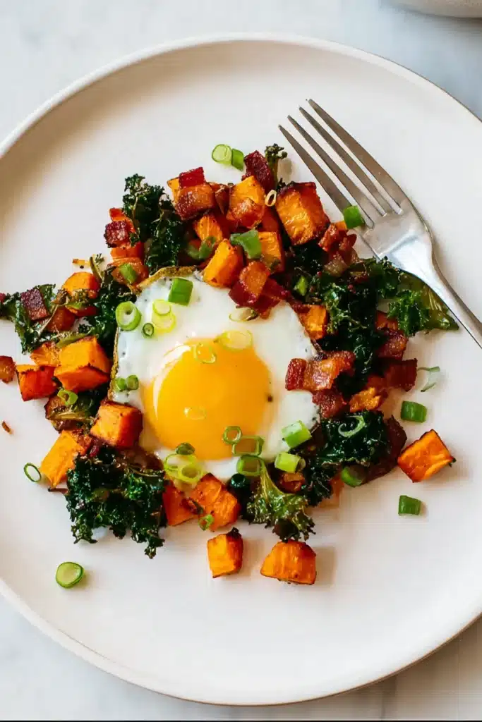 Sweet Potato Breakfast Hash Recipe You’ll Love Every Morning 3 Sweet potato breakfast hash served on plate with egg and bacon