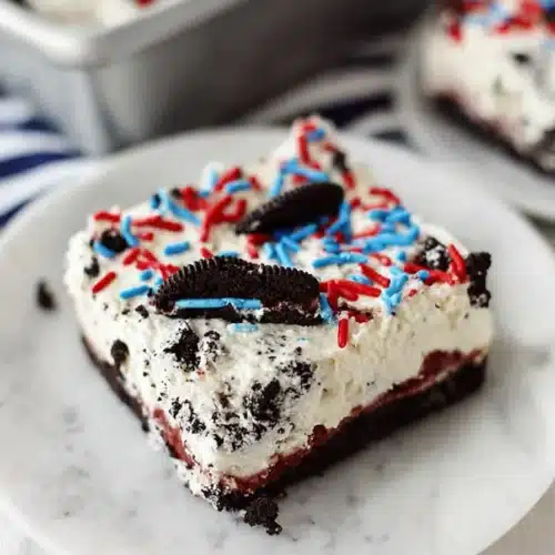 No bake Oreo cheesecake bars with sprinkles on white plate