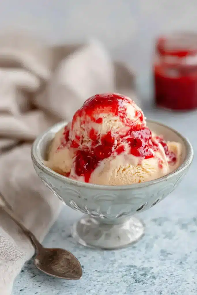 Rhubarb Ice Cream with red fruit topping in dessert bowl