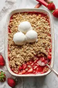 Strawberry Rhubarb Crisp with oat topping and vanilla ice cream