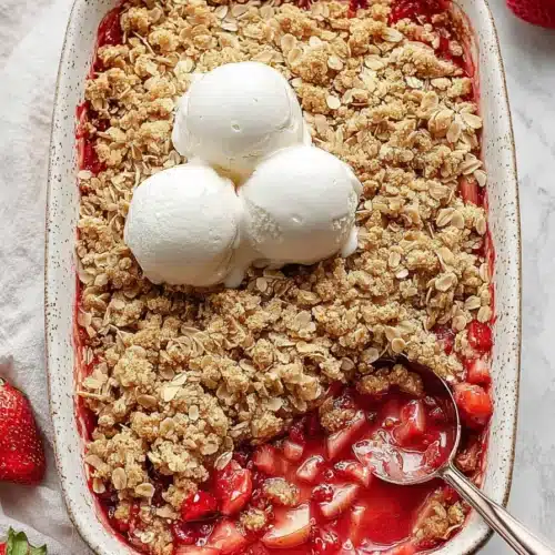 Strawberry Rhubarb Crisp with oat topping and vanilla ice cream