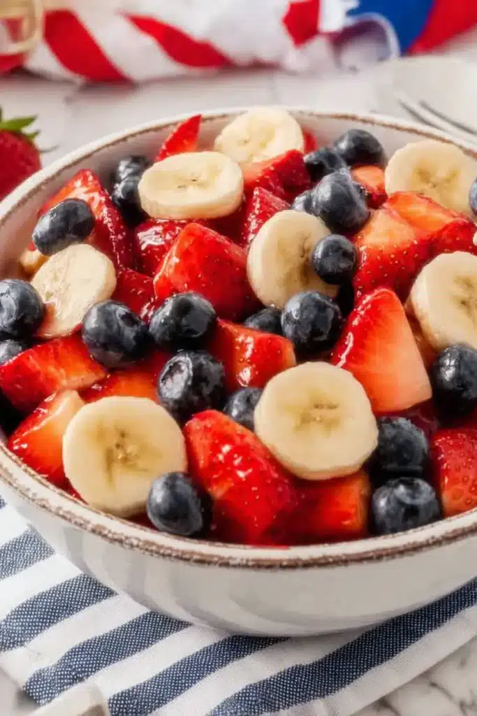 4th of July Fruit Salad with strawberries blueberries and bananas in a serving bowl