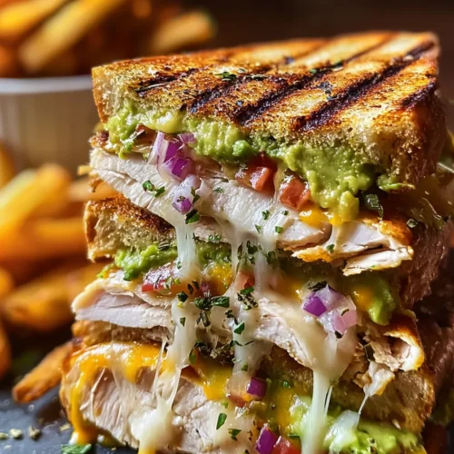 Chicken Avocado Melt Sandwich 3 Chicken Avocado Melt Sandwich with crispy bread, melted cheese, chicken, and avocado