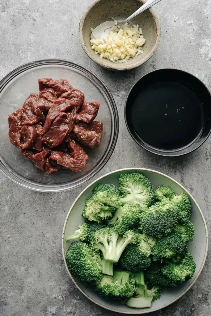Chinese Beef and Broccoli cooking in skillet with glossy sauce and fresh broccoli