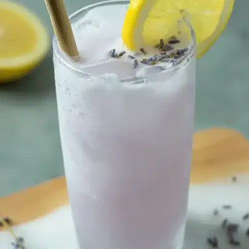 Coconut Lavender Lemonade Mocktail 4 Coconut Lavender Lemonade Mocktail served over ice with lemon garnish