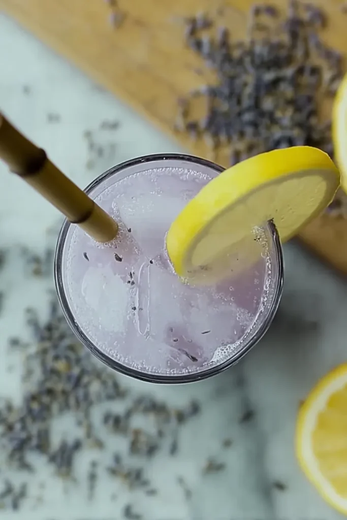 Coconut Lavender Lemonade Mocktail 2 Top view of Coconut Lavender Lemonade Mocktail with ice and lemon garnish
