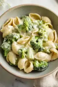 Creamy broccoli pasta with shell pasta and cheesy garlic sauce in a rustic bowl
