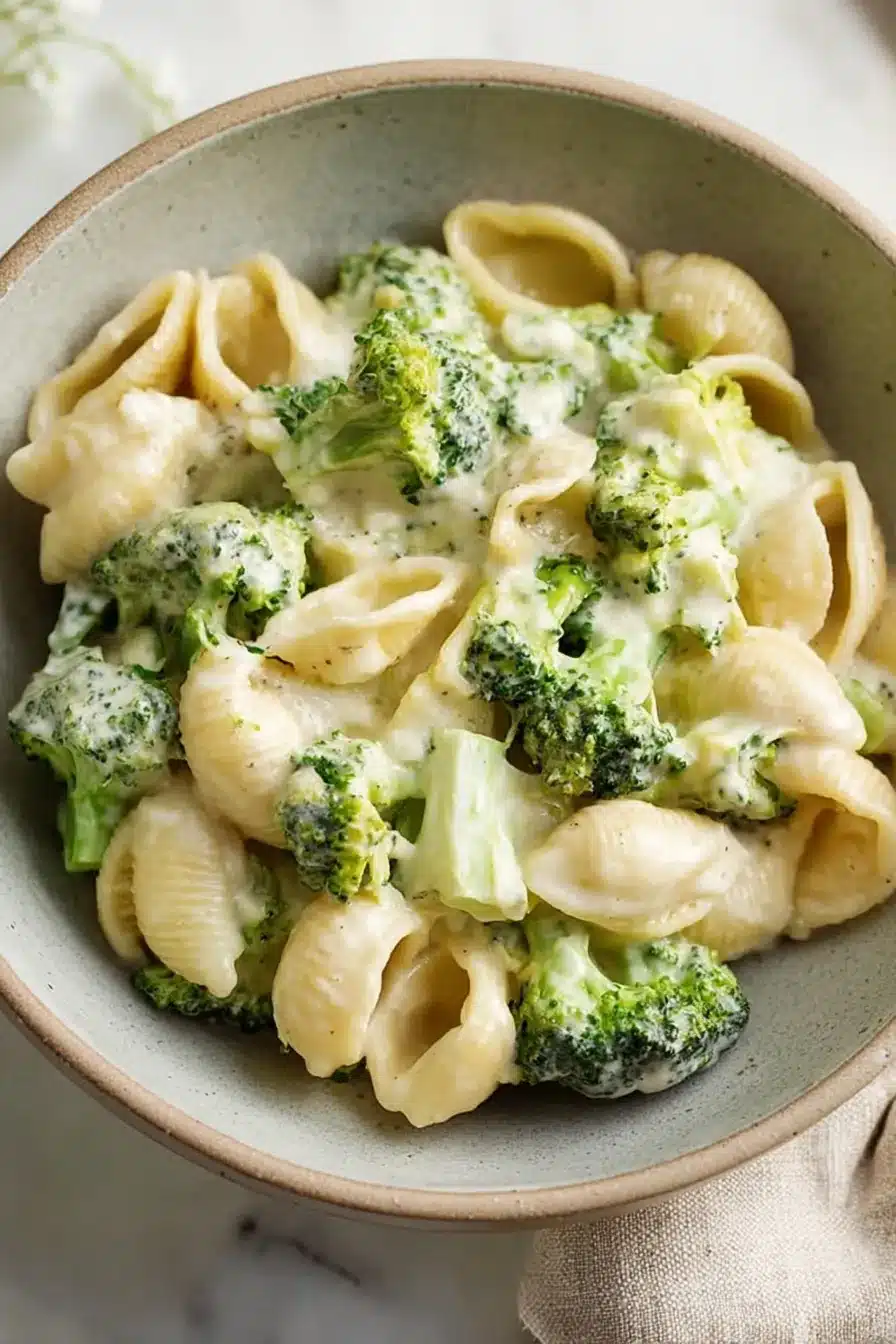Creamy broccoli pasta with shell pasta and cheesy garlic sauce in a rustic bowl