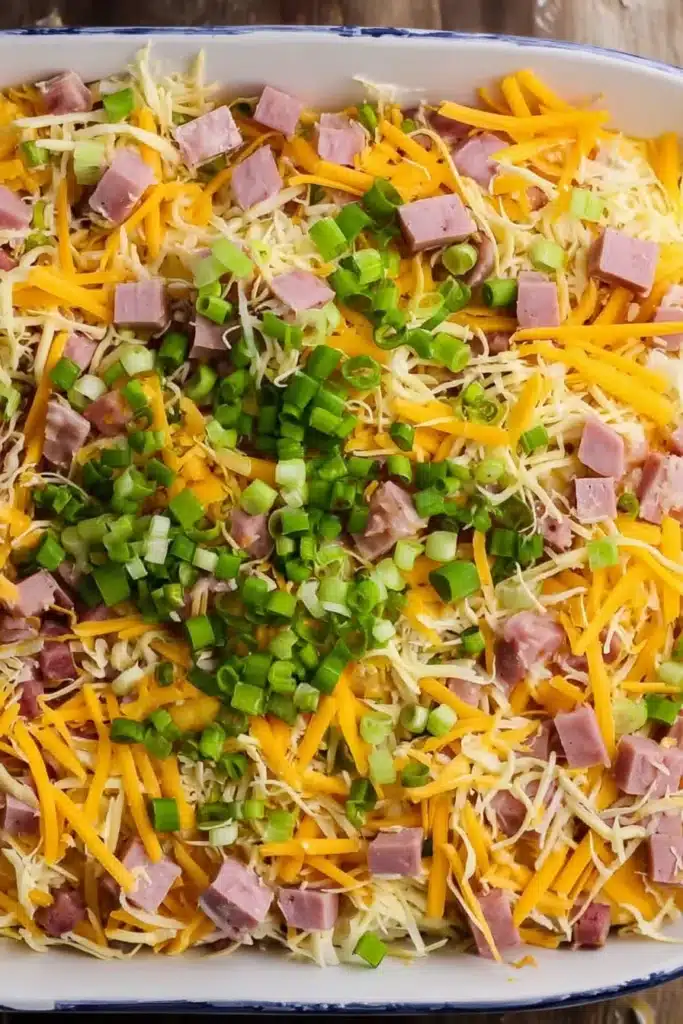 Hash Brown Egg Casserole layered with cheese ham and scallions