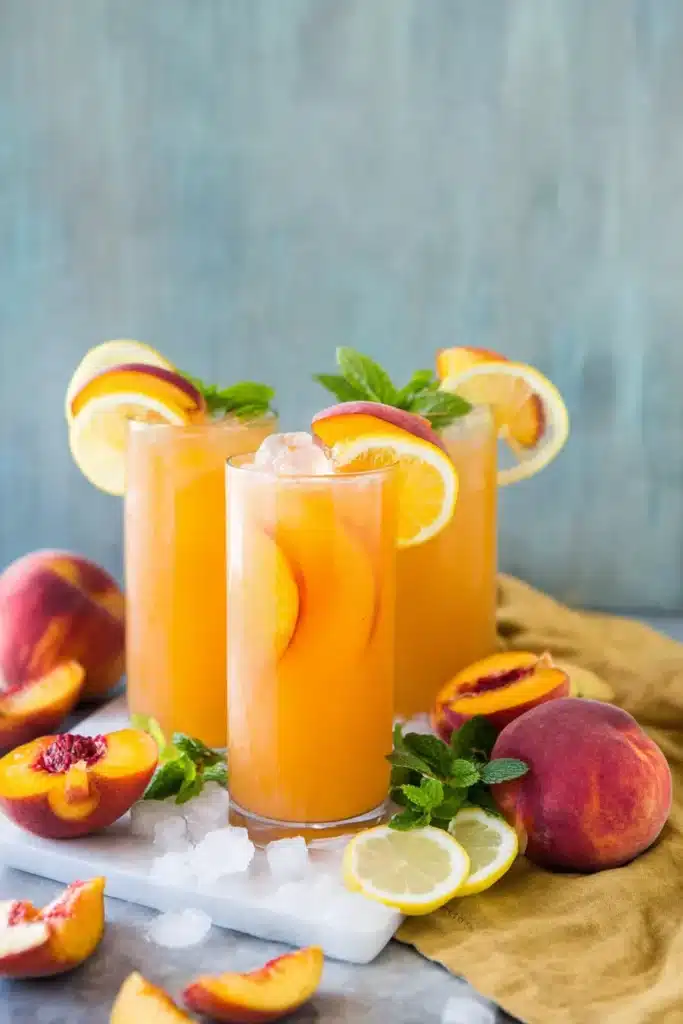 Peach Lemonade served over ice with peaches, lemons, and mint