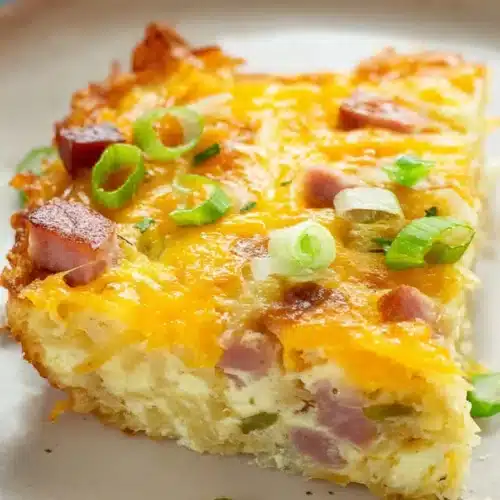 Hash Brown Egg Casserole slice with cheese ham and green onions