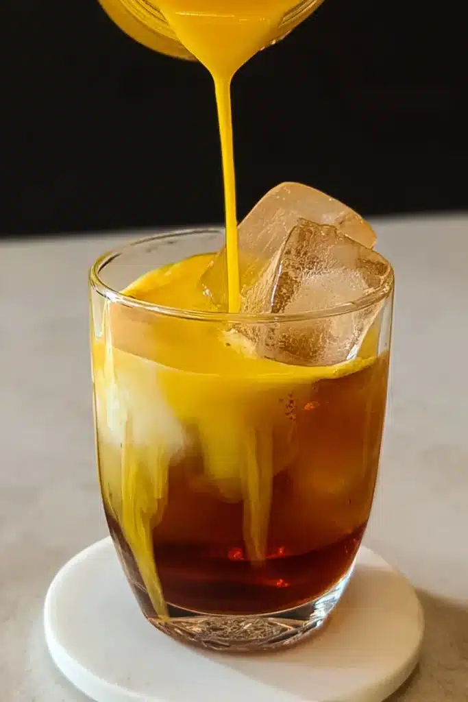 Homemade Mango Iced Tea with mango puree poured over iced tea